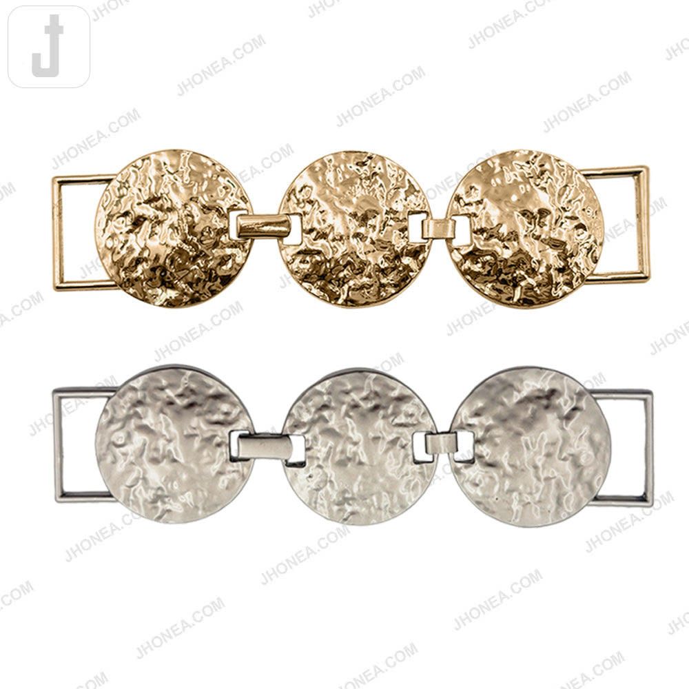 Textured round metal belt buckle in shiny gold and matte silver finish