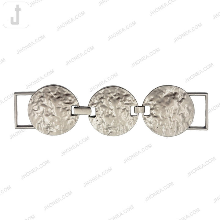 Textured round metal belt buckle in matte silver finish