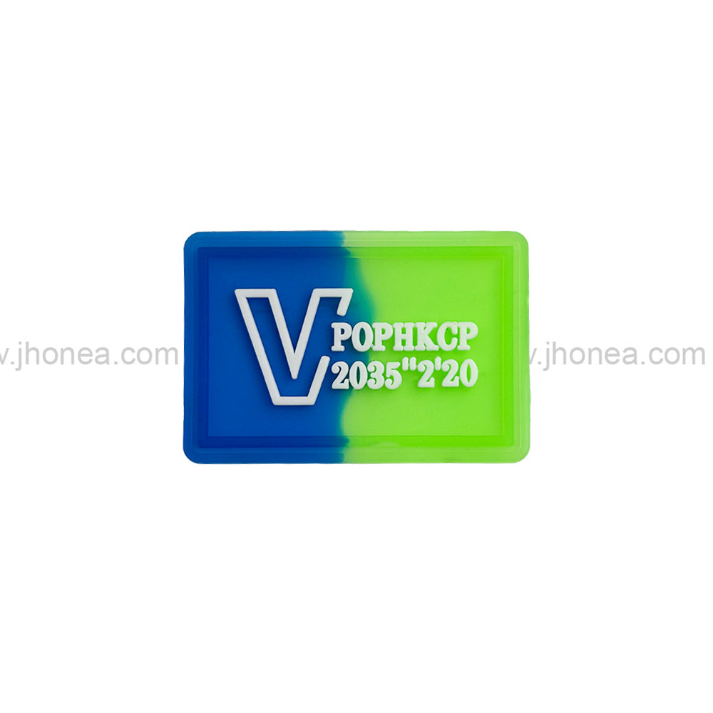 Dual tone embossed logo silicone patch in blue and green for clothing and bags