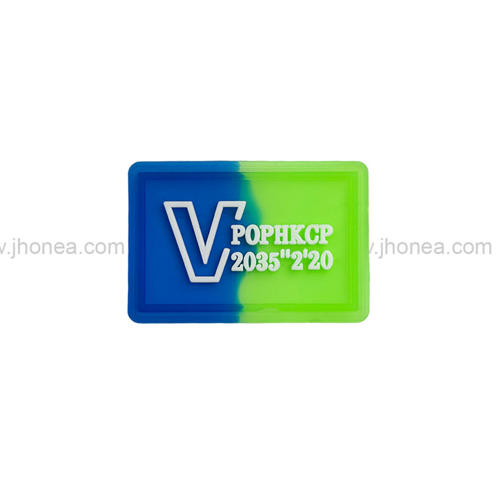 Dual tone embossed logo silicone patch in blue and green for clothing and bags